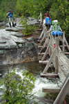 backpackers crossing bridge